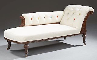 American Inlaid Carved Walnut Recamier, late 19th c., with a multi-colored button tufted back and rolled arm, on turned taper