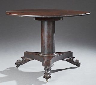 French Empire Style Carved Mahogany Tilt Top Center Table, 20th c., the circular top over a cylindrical pedestal to a tripoda