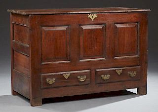 French Carved Oak Coffer, 19th c., the lifting lid storage area over a paneled case with two lower drawers, on block feet, H.