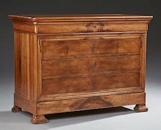 French Louis Philippe Carved Walnut Commode, c. 1860, the rounded corner rectangular top over a cavetto frieze drawer and thr