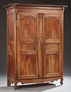 Louis XV Style Carved Walnut Armoire, c. 1850, the canted corner stepped crown over triple panel doors with iron escutcheons 