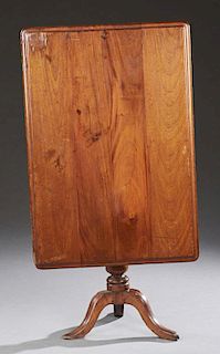 English Carved Mahogany Tilt Top Breakfast Table, 19th c., the stepped rectangular top on a turned tapered pedestal to a trip