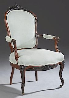 American Louis XV Style Carved Walnut Fauteuil, 19th c., the floral carved crest rail over a shield back, upholstered arms an