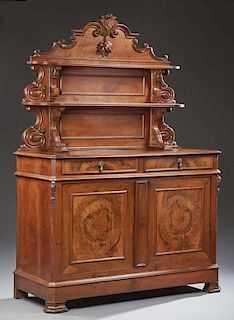 French Louis Philippe Carved Walnut Sideboard, c. 1850, the arched leaf and fruit carved back over two graduated shelves on s