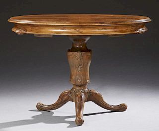 French Louis Philippe Carved Walnut Dining Table, 19th c., the stepped circular top over a wide rounded skirt on a tapered ur