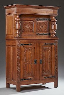 French Louis XIII Style Carved Oak Sideboard, c. 1880, the stepped ogee crown over a wide double panel cupboard door, with ir