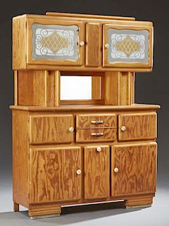 French Carved Pine Kitchen Cupboard, mid 20th c., the top with two glazed doors over a lower center mirror flanked by open st