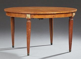 French Ormolu Mounted Inlaid Carved Walnut Dining Table, 20th c., the circular top opening to accept leaves over a wide skirt