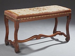 French Louis XIII Style Carved Walnut Music Bench, late 19th c., with original needlework upholstery seat on a reeded skirt o