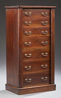 English Carved Walnut Sidelock Chest, 19th c., the rounded corner rectangular top over seven drawers flanked by hinged lockin
