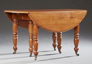 Louis Philippe Carved Cherry Drop Leaf Dining Table, 19th c., the circular top with a stepped rounded edge, on six turned and