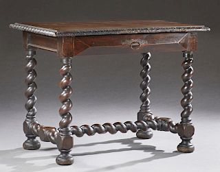 French Louis XIII Style Carved Walnut Writing Table, late 19th c., the carved edge top over a wide skirt with a frieze drawer