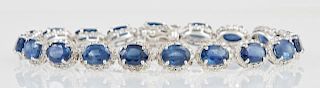 14K White Gold Link Bracelet, each of the 19 oval links with an oval blue sapphire atop a border of round diamonds, total sap