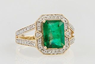 Lady's 18K Yellow Gold Dinner Ring, with a 2.04 carat emerald atop an octagonal border of round diamonds, the split shoulders