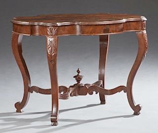 American Rococo Revival Carved Mahogany Parlor Table, 19th c., the serpentine stepped edge top over a wide skirt, on leaf car