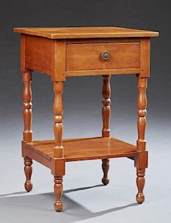 American Carved Maple Lamp Table, early 20th c., the square top over a frieze drawer, on turned tapered supports to a lower s