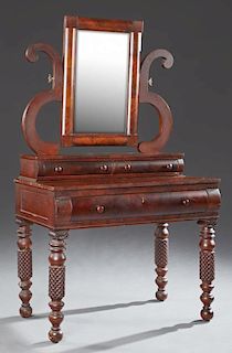 American Classical Carved Mahogany Dressing Table, 19th c., the rectangular mirror on S-scroll supports to a bank of two conv