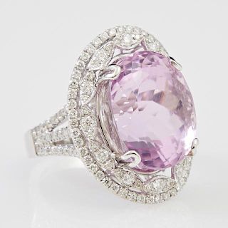 Lady's 18K White Gold Dinner Ring, with a 23.12 carat oval Kunzite atop a marquise shaped border mounted with round diamonds,