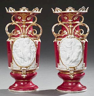 Pair of Unusual Continental Porcelain Handled Baluster Vases, 19th c., the crenelated rims over gilt decorated magenta ground