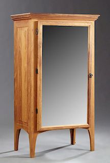 Louisiana Carved Cypress Mirrored Cabinet, 21st c., by Le Charpentier, New Orleans, the rectangular stepped top over a rectan