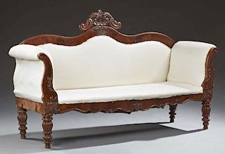 American Classical Carved Mahogany Sofa, 19th c., the serpentine back with a central scroll and floral crest, over an upholst
