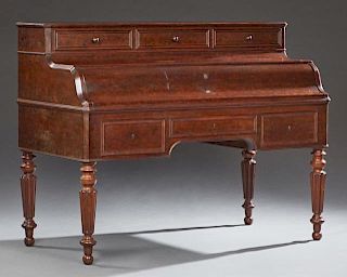 French Louis Philippe Carved Mahogany Cantilevered Desk, c. 1850, the canted corner top with a bank of three fall front file 