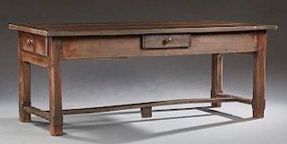 French Provincial Carved Walnut Farmhouse Table, 19th c., the thick rectangular three board plank top over a wide skirt with 