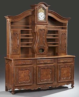 French Provincial Carved Walnut and Cherry Louis XV Style Vaisselier, 19th c., the superstructure centered with a clock, time