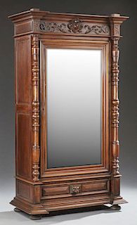 French Mahogany Armoire, c. 1880, the stepped breakfront over a setback wide beveled glazed mirror door, flanked by turned ta