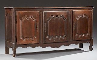 French Louis XV Style Carved Walnut Sideboard, late 19th c., the rounded edge and corner rectangular top over three fielded p