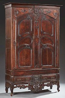 Unusual French Louis XV Style Carved Cherry and Oak Armoire, c. 1880, the stepped breakfront crown over double arched three p