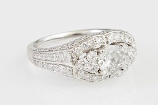 Lady's Platinum Dinner Ring, with a .92 carat round diamond flanked by two round diamonds, within a border of small round dia