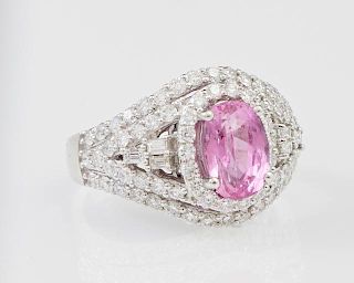 Lady's Platinum Dinner Ring, with an oval 2.39 carat pink sapphire atop a border of small round diamonds, supported by round 