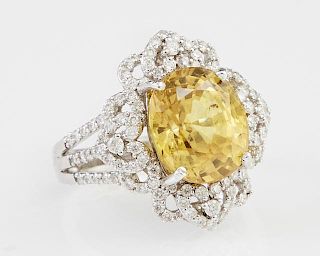 Lady's Platinum Dinner Ring, with an oval 7.68 carat yellow sapphire, atop a pierced diamond mounted heart and loop border, t