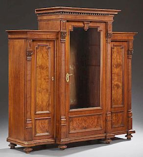 American Renaissance Revival Carved Walnut Stepback Bookcase, c. 1870, the tall center section with a stepped dentillated cro