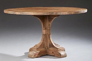 Continental Style Carved Walnut Circular Dining Table, late 20th c., the segmented top within a wide border on a tiered squar