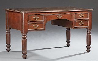 English Victorian Carved Walnut Desk, 19th c., the rounded edge stepped corner top with an inset gilt tooled leather writing 
