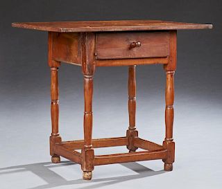 American Primitive Side Table, 19th c., the rectangular top over a deep drawer on turned tapered legs joined by a box stretch