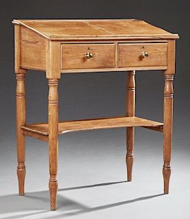 American Carved Pine Warehouseman's Desk, 19th c., the slanted top over two frieze drawers, on turned tapered legs joined by 