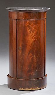 English Carved Mahogany Columnar Marble Top Nightstand, 19th c., the figured black marble over a cupboard door opening to thr