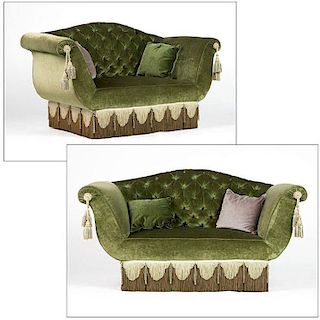A pair of green upholstered love seats