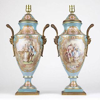 A pair of French porcelain Sevres-style urns mounted as lamps