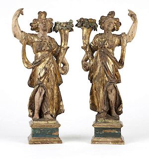 A pair of Italian polychrome & gilt carved pine candelabra
