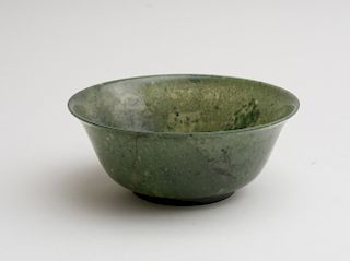 CHINESE CARVED SPINACH GREEN JADE FOOTED BELL-FORM BOWL