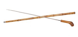 42. Toledo Sword Cane- Ca. 1900-A bamboo root handle, signed Toledo 23” blade with a push and pull mechanism, nice bamboo shaft and a metal ferrule. O