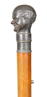 47. Spitting/Cologne Cane- Late 19th Century- A working example of a Britannia head of a comical character which has a small hole in its’ mouth, there