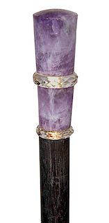 65. Amethyst Dress Cane- Ca. 1890- A decorative amethyst handle with rock crystal faceted rings, ebony shaft and a brass ferrule. H.- 2 ½” x 1” O.L.- 