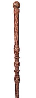 82. Dual Purpose Macramé Cane- Ca. 1880- Dual purpose that doubles as a defensive cane finely woven throughout with various collars and chains, fine c