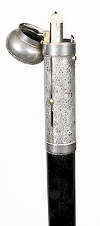 84. Push-up Candle Cane- Late 19th Century- A German nickel plated brass handle which contains a compartment for matches and a push-up candle, “Nordde