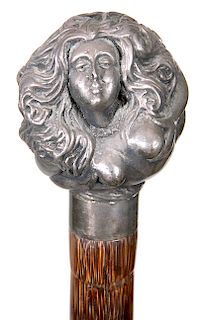 88. Erotic Dress Cane- Ca. 1890- A signed sterling handle of a nude lady holding her breast with flowing hair, small silver collar, faux bamboo partri